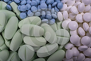 Pills lie on table macro closeup. Drugs, painkillers, colds and other medicines.