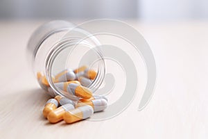 Pills on a light wooden table