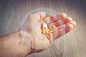 Pills in man`s hand close-up. Health and medicine. Pharmaceuticals. Take pills, treatment.