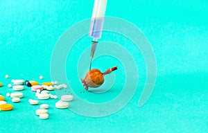 Pills and medical syringe on blue background. Painkiller or narcotic  prescription for treatment medication