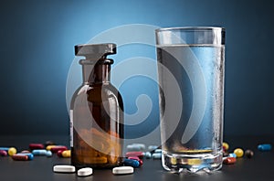 Pills medicine bottle and glass of drink water