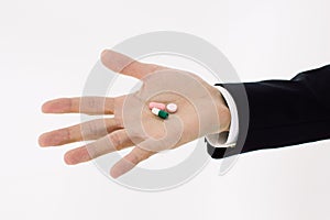 Pills on men hand