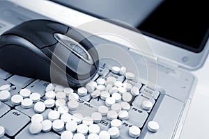 Pills and mouse on keyboard