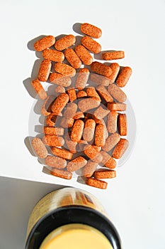 Pills next to a Container