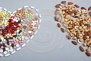 Pills and nuts different types in the shape of heart. Healthy  concept