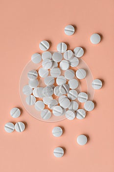 Pills on orange background, medical supplement concept