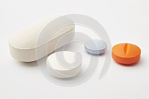 Pills over a white background. Medicament treatment. Health care