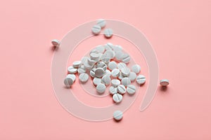 Pills on pink background, supplement concept