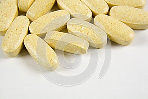 Pills scattered on a gray background.