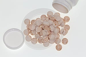 Pills scattered on a white background