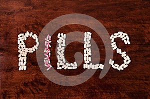 Pills sign on wood background