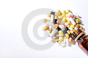Pills spilled out of pill bottle, top view. Medication and medicine tablets. Copy space