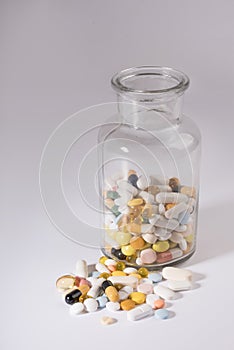 Pills spilled out of pill bottle, top view. Medication and medicine tablets. Copy space