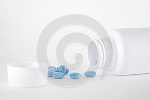 Pills spilling from a bottle