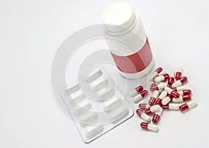 Pills Spilling From An Open Bottle On Pink Background