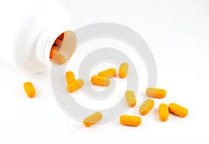 Pills spilling out of bottle photo