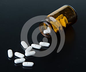 Pills spilling out of pill bottle