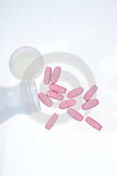 Pills spilling out of pill bottle. Assorted pharmaceutical medicine pills, tablets and capsules on white background. Antiretrovira