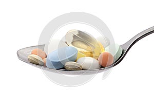 Pills on spoon with clipping path