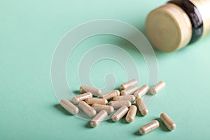 Pills, tablets and bottle on turquoise background. Copy space for text