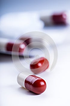 Pills. Tablets. Capsule. Heap of pills. Medical background. Close-up of pile of red white tablets - capsule. Pills and tablets.
