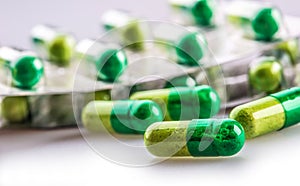 Pills. Tablets. Capsule. Heap of pills. Medical background. Close-up of pile of yellow green tablets