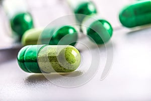 Pills. Tablets. Capsule. Heap of pills. Medical background. Close-up of pile of yellow green tablets