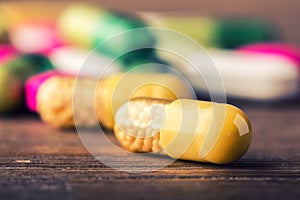 Pills. Tablets. Capsule. Heap of pills. Medical background. Close-up of pile of yellow green tablets - capsule. Pills and tablets