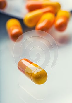 Pills Tablets Capsule or Medicament freely laid on glass background