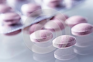 Pills Tablets Capsule or Medicament freely laid on glass background photo