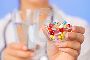 Pills, tablets and drugs heap in doctor hand