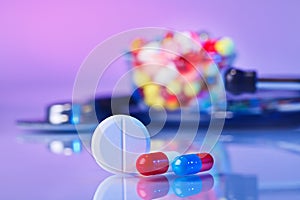 Pills and tablets macro still life on violet photo