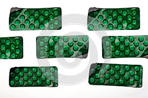 Pills and tablets on white background