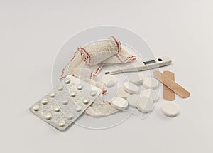 Pills, thermometer, bandage and plasters