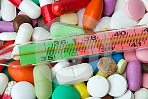 Pills and thermometer - medical background