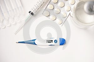 Pills, thermometer and syringes on white background. Coronavirus COVID-19 epidemic. Flat lay, top view, copy space