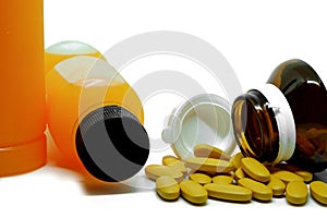 Pills of vitamin C and fresh orange juice bottle on white background