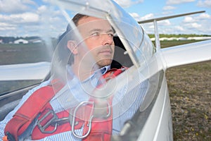 Pilot aerobatic plane sitting in cockpit