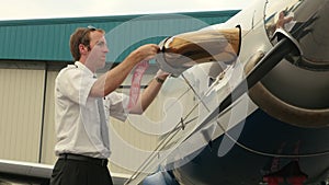 Pilot Attaches Post-Flight Safety Covers Ribbons to Engine