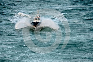 Pilot boat seen from the sky sailing in the middle of a storm