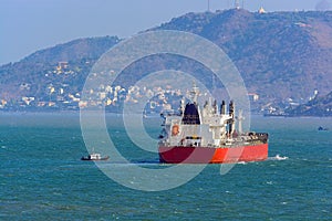 Pilot boat and bulk cargo ship.