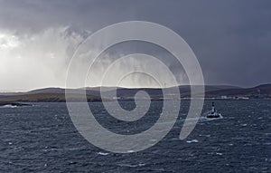 The Pilot Boat Knab ahead of a Vessel approaching Bressay Sound in a Winters squall in the Shetland Islands photo