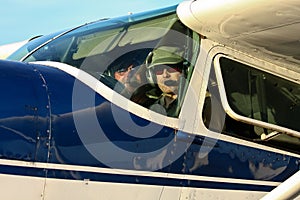 Pilot and co-pilot in cockpit of Cessna 180