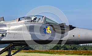 Pilot in the cockpit of a MiG-29 Fulcrum fighter jet plane taxiing towards the runway at Florennes Airbase. Belgium - June 15, photo