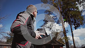 The pilot controls with the drone and looks into the sky