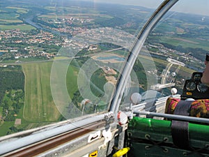 The view from the cockpit of a glider in flight.