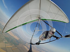 Pilot controls his hang glider wing on hign altitude