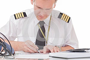 Pilot filling in logbook and checking papers