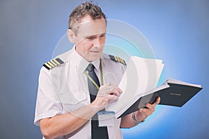 Pilot filling in logbook and checking papers photo