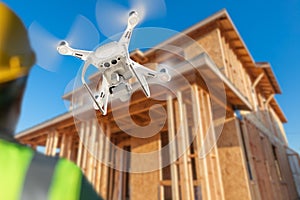 Pilot Flies Drone Inspecting Home Construction Site